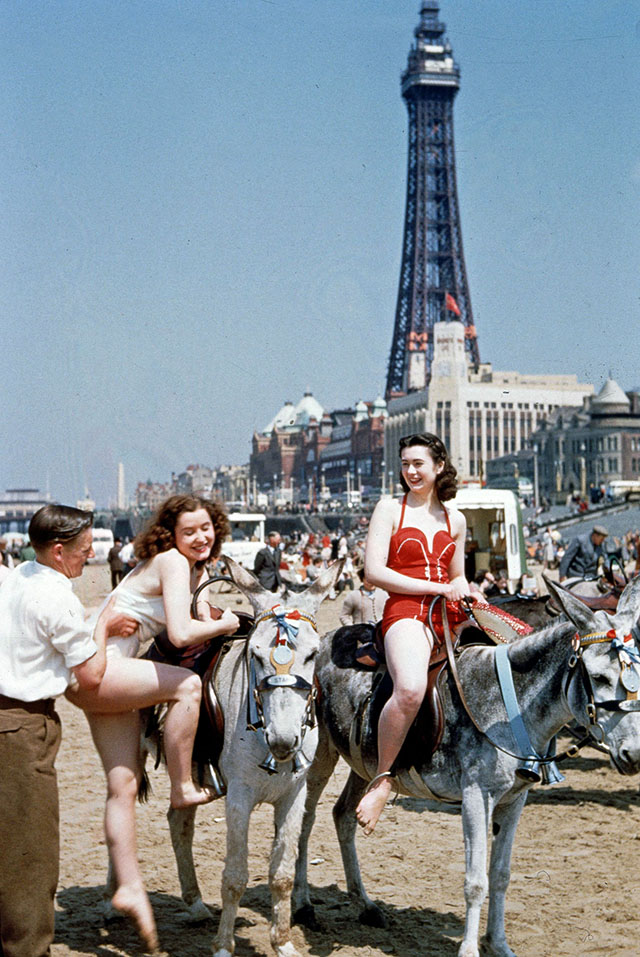 circa 1950:  Holiday-makers riding donkeys on the beach at Blackpool. Blackpool Tower is in the background. Original Publication: Picture Post - 7227 - Blackpool - pub. 1954  (Photo by John Chillingworth/Picture Post/Getty Images)